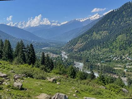 Green valley and snowy peaks