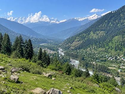 Green valley and snowy peaks