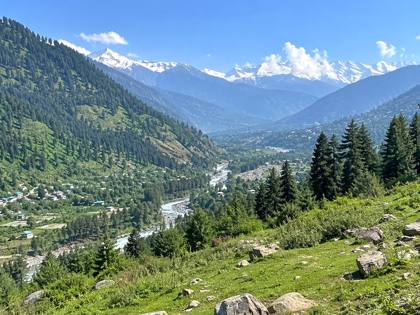 Green valley and snowy peaks