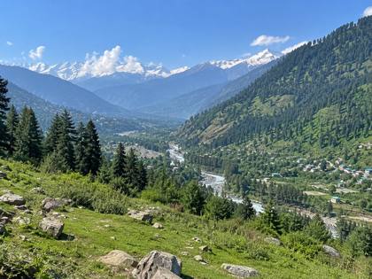 Green valley and snowy peaks